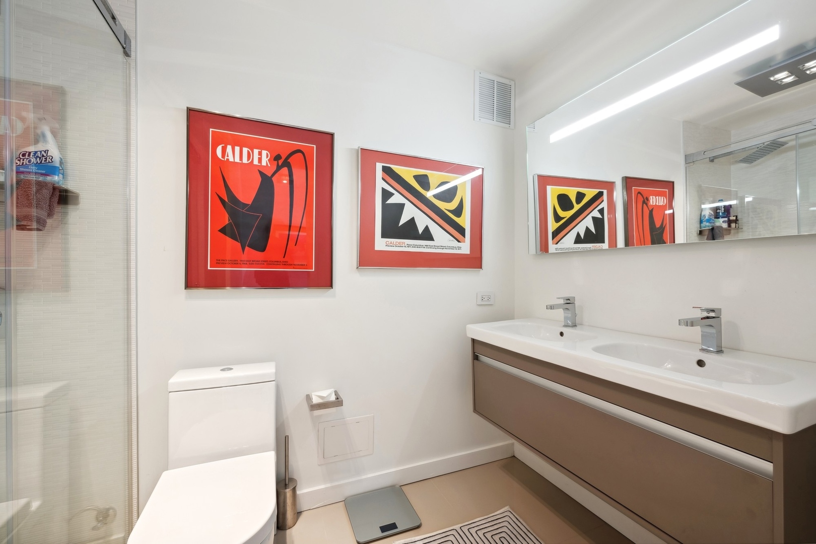 100 East Walton Street, Unit 32FG Chicago, IL 60611 - Photo 14 of 30 a bathroom with a toilet sink and mirror