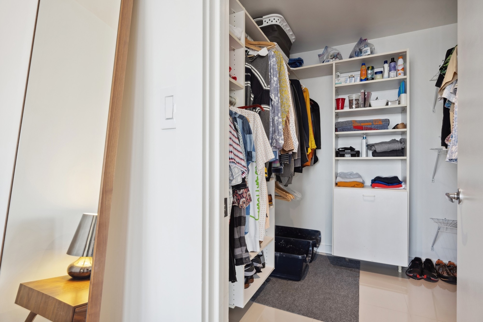 100 East Walton Street, Unit 32FG Chicago, IL 60611 - Photo 15 of 30 a view of walk in closet with clothes and shoes