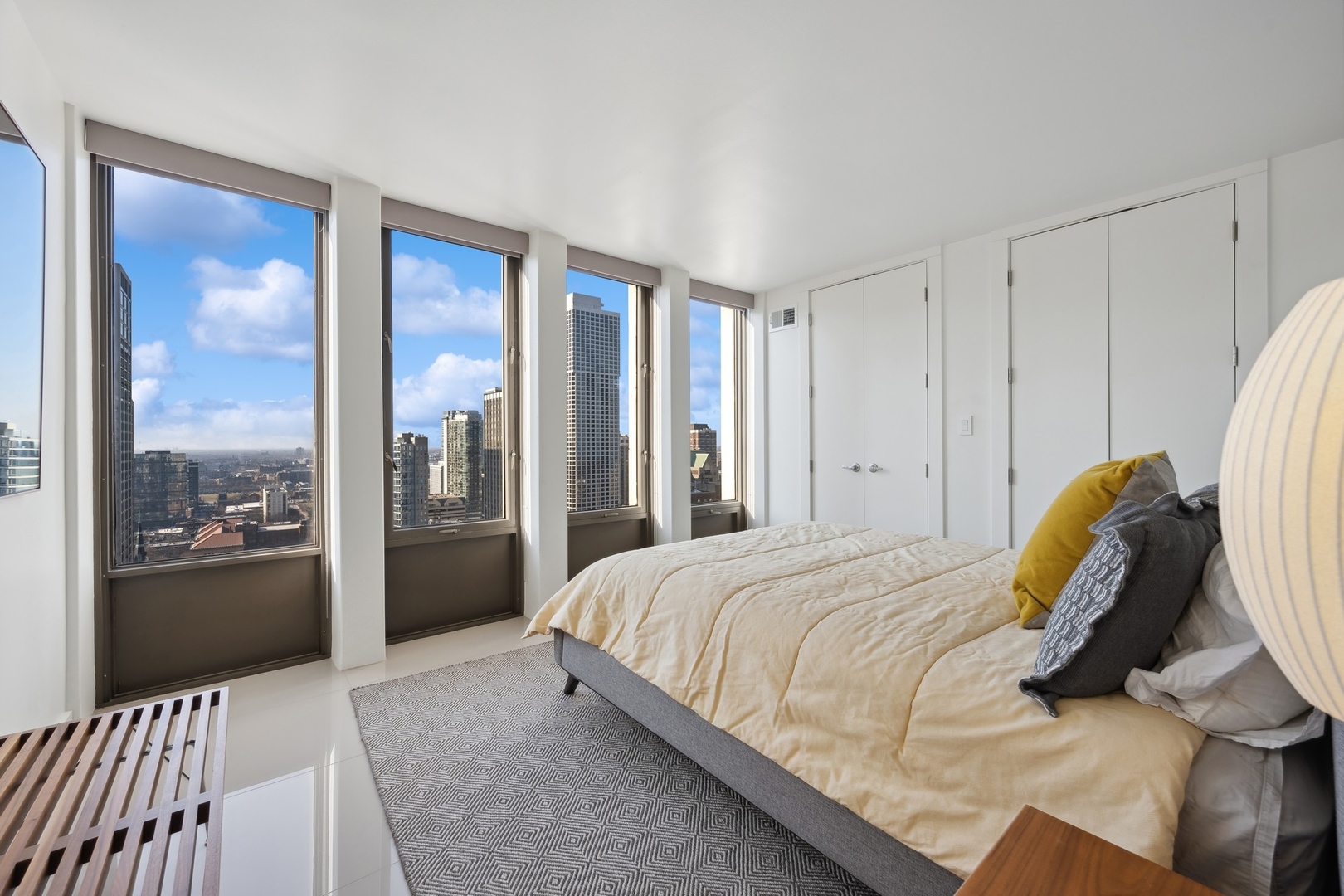 100 East Walton Street, Unit 32FG Chicago, IL 60611 - Photo 16 of 30 a bedroom with a bed and a large window