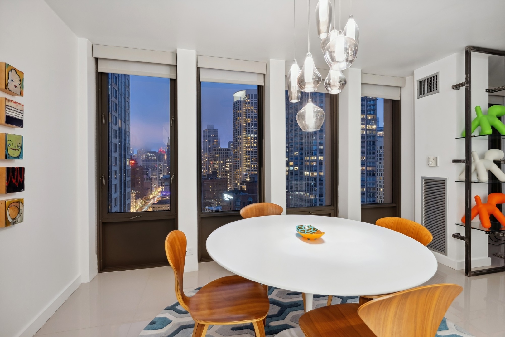 100 East Walton Street, Unit 32FG Chicago, IL 60611 - Photo 23 of 30 a view of a dining room with furniture and chandelier