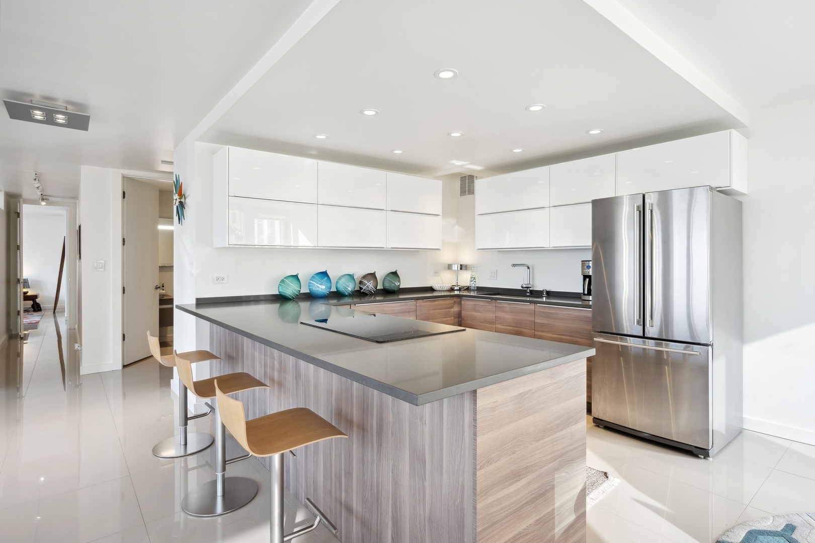 100 East Walton Street, Unit 32FG Chicago, IL 60611 - Photo 6 of 30 a kitchen with stainless steel appliances granite countertop a refrigerator a sink and a stove