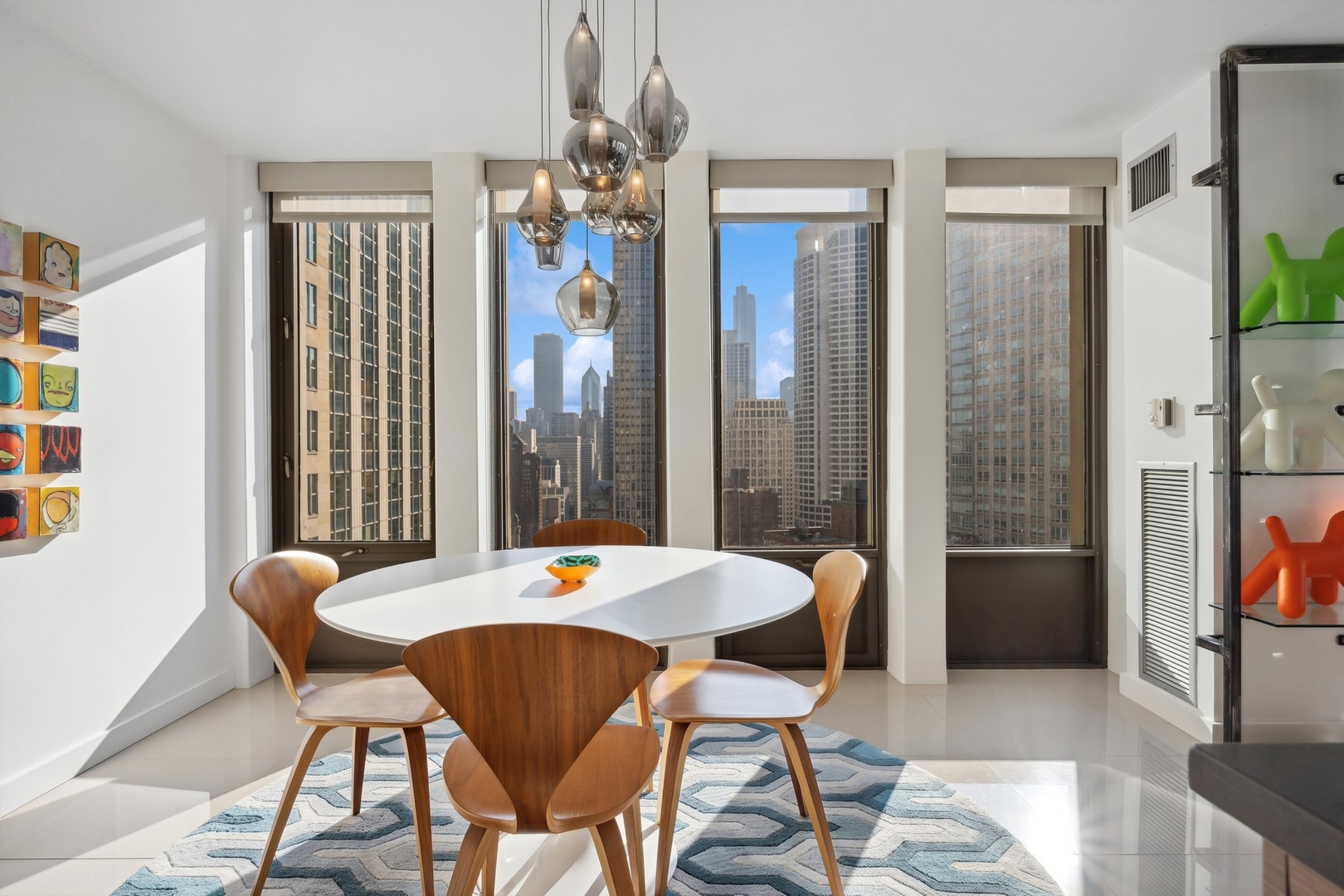 100 East Walton Street, Unit 32FG Chicago, IL 60611 - Photo 10 of 30 a view of a dining room with furniture and chandelier