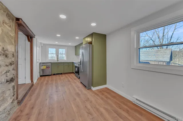 a view of a kitchen with wooden floor and a sink