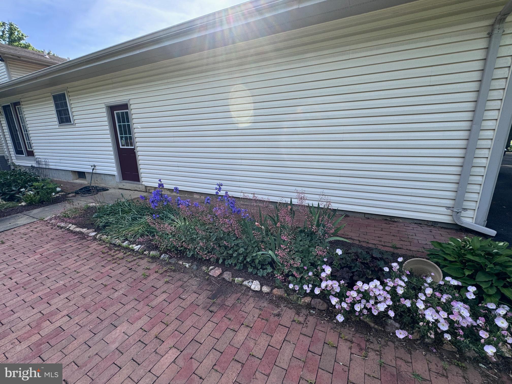 6375 Union Mill Road Clifton, VA 20124 - Photo 11 of 34 a view of a house with a yard and a garden