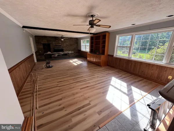 a open kitchen with cabinets wooden floor and stainless steel appliances