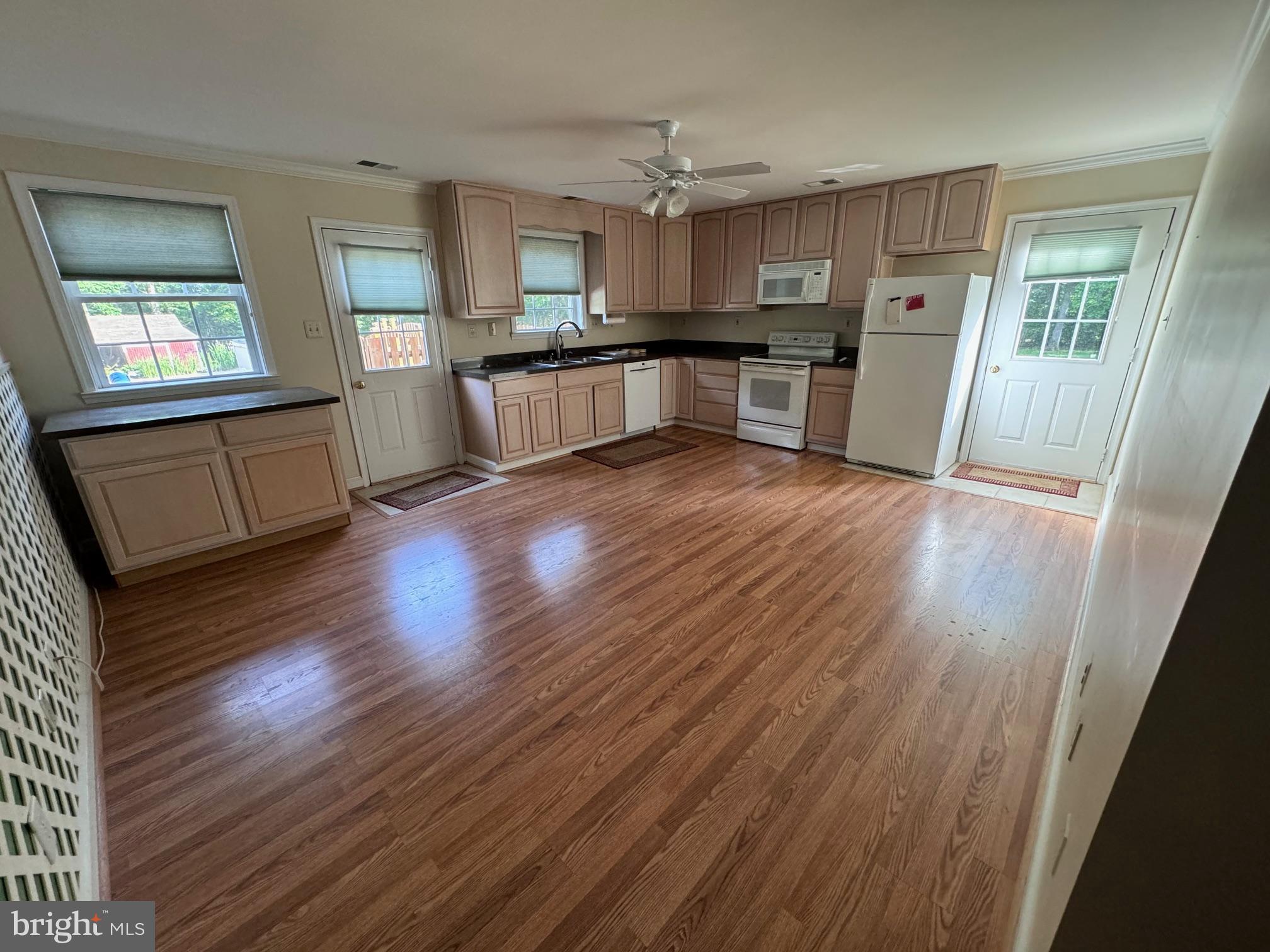 6375 Union Mill Road Clifton, VA 20124 - Photo 18 of 34 a open kitchen with cabinets wooden floor and stainless steel appliances