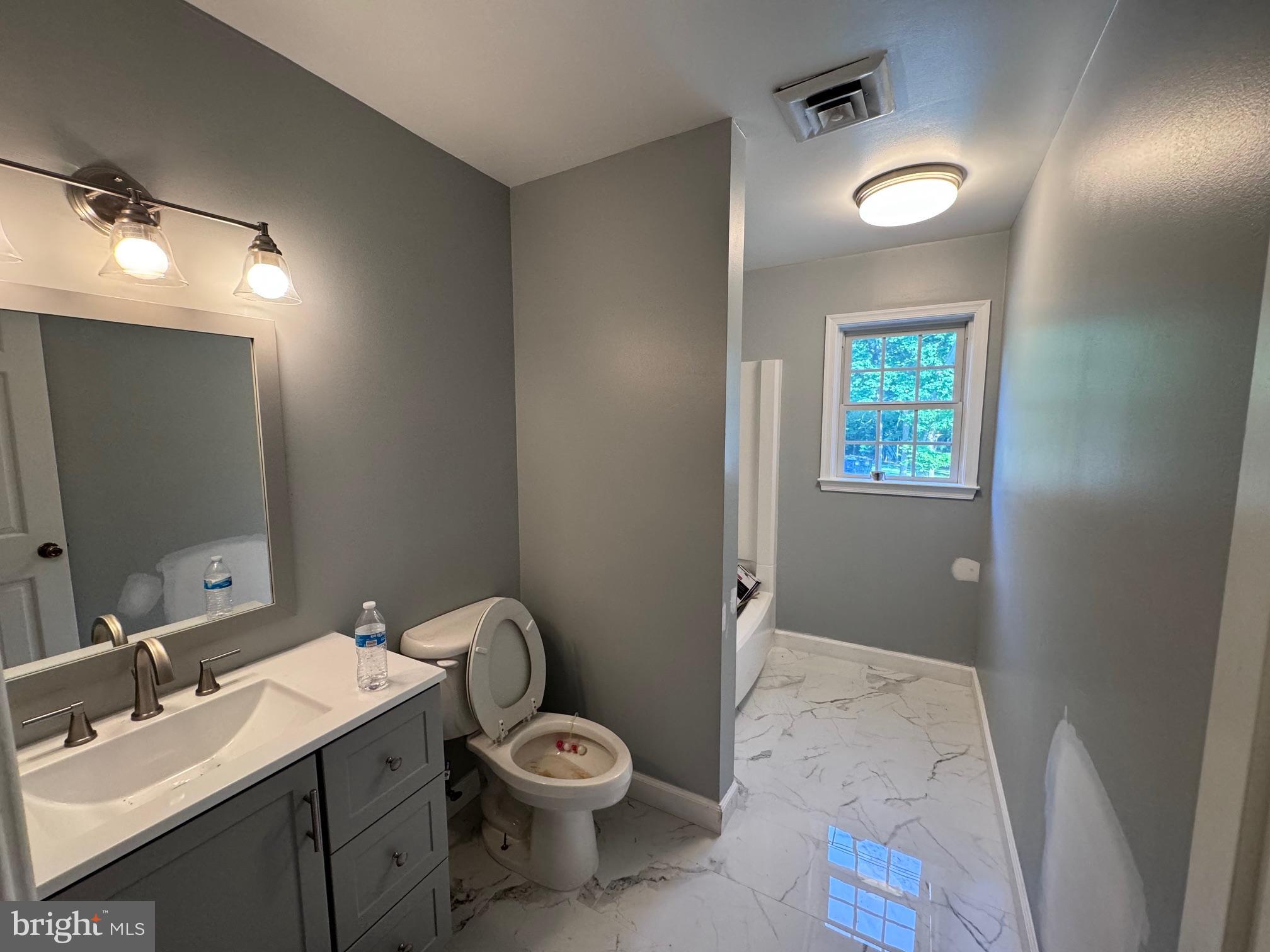 6375 Union Mill Road Clifton, VA 20124 - Photo 27 of 34 a bathroom with a toilet sink and mirror