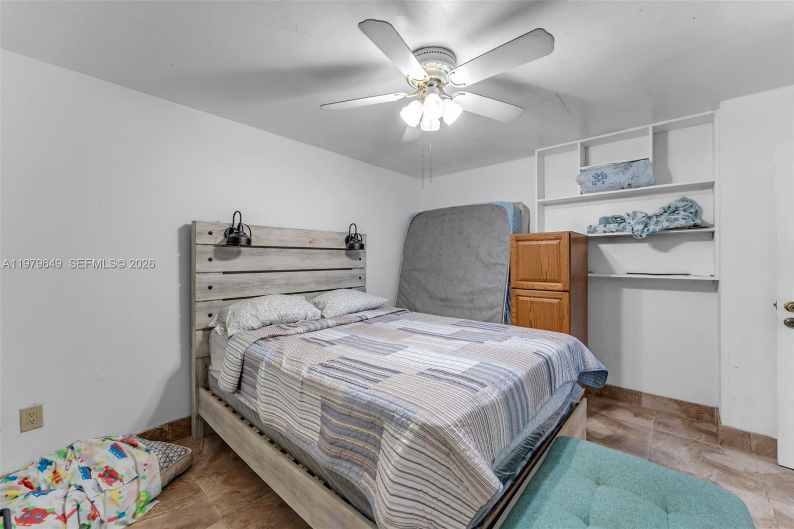 174 Corrine Place, Unit 1 Key Largo, FL 33037 - Photo 11 of 17 a bedroom with a bed and a chandelier