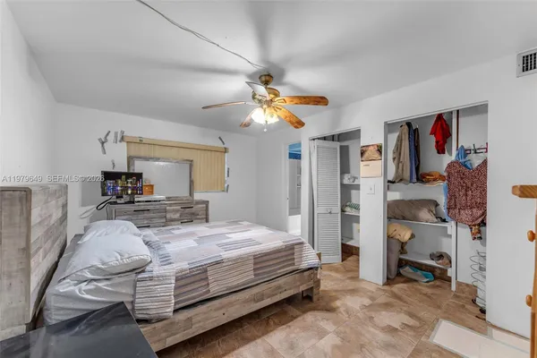 a bedroom with a bed and a walk in closet