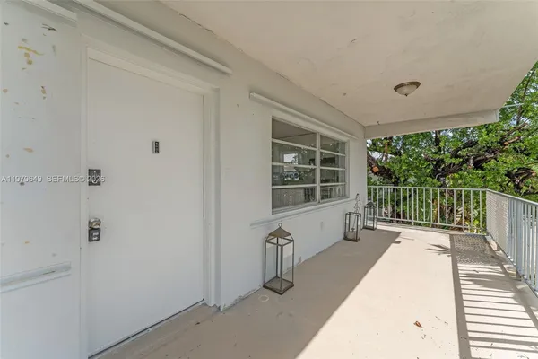 a view of a balcony with wooden floor
