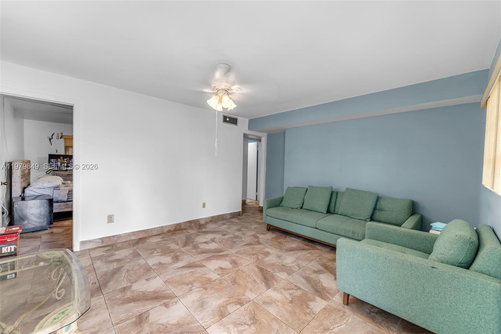 174 Corrine Place, Unit 1 Key Largo, FL 33037 - Photo 3 of 17 a living room with furniture and a chandelier