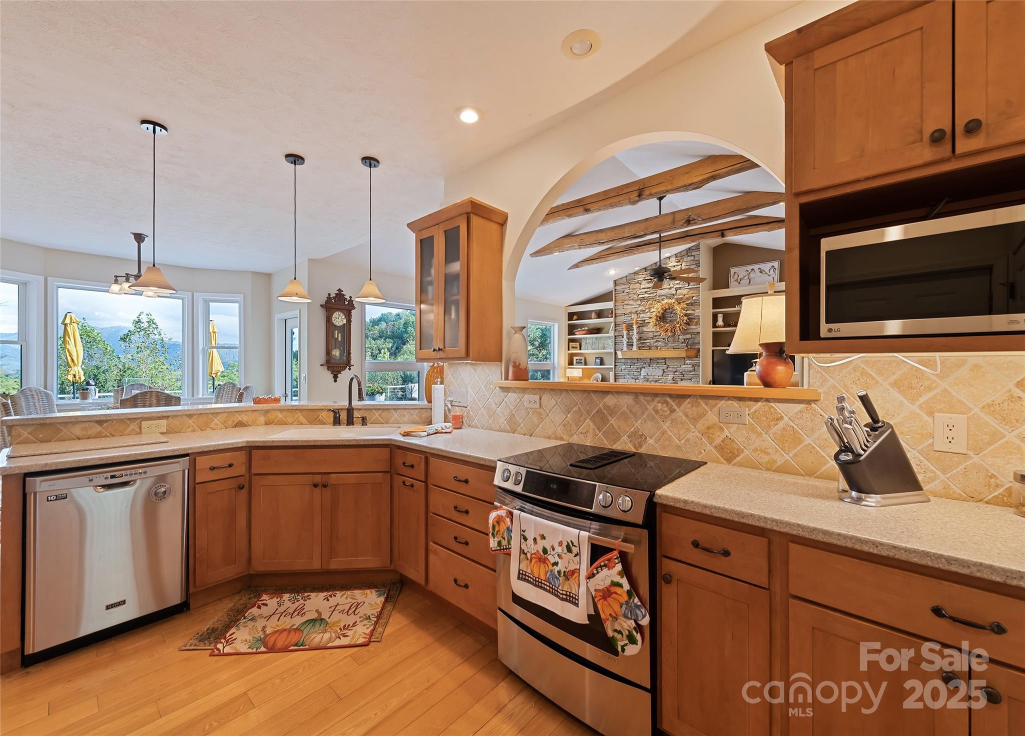 966 Coyote Hollow Road Waynesville, NC 28785 - Photo 12 of 29 a kitchen with stainless steel appliances granite countertop a sink a stove and a microwave