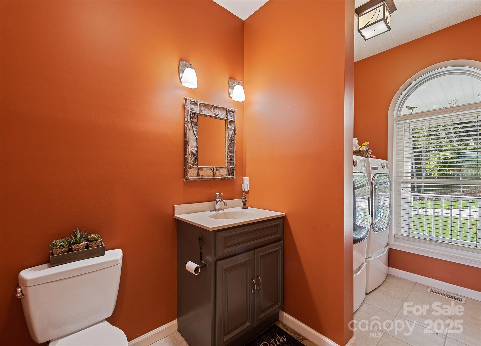 966 Coyote Hollow Road Waynesville, NC 28785 - Photo 19 of 29 a bathroom with a toilet a sink and mirror