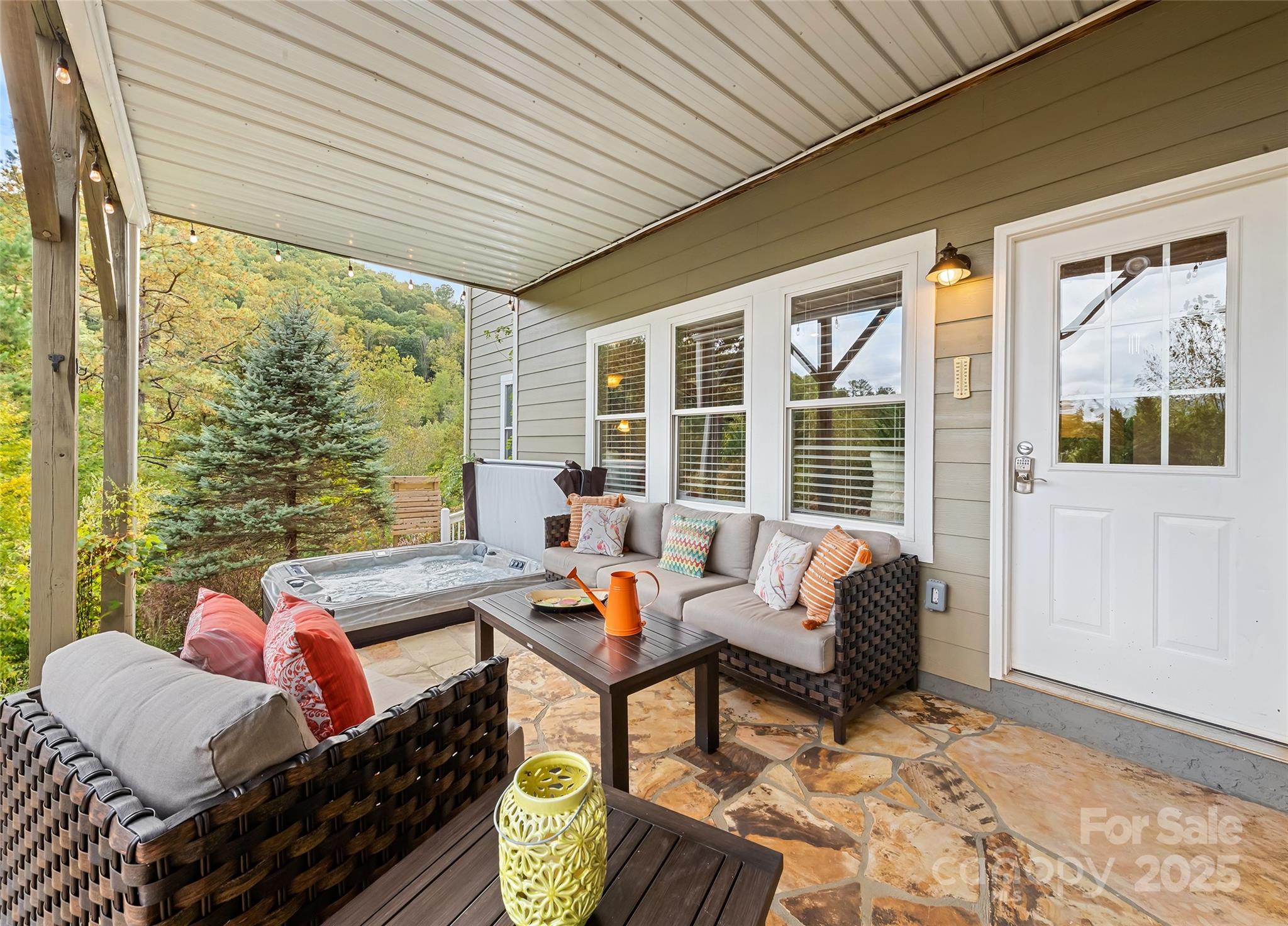 966 Coyote Hollow Road Waynesville, NC 28785 - Photo 27 of 29 a outdoor space with patio the couches and dining table with a potted plant