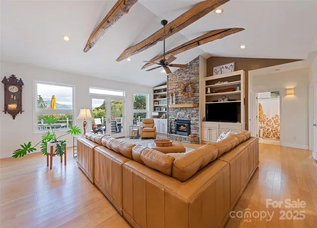 a living room with fireplace furniture and a wooden floor