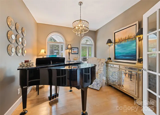 a living room with furniture a flat screen tv and a sink