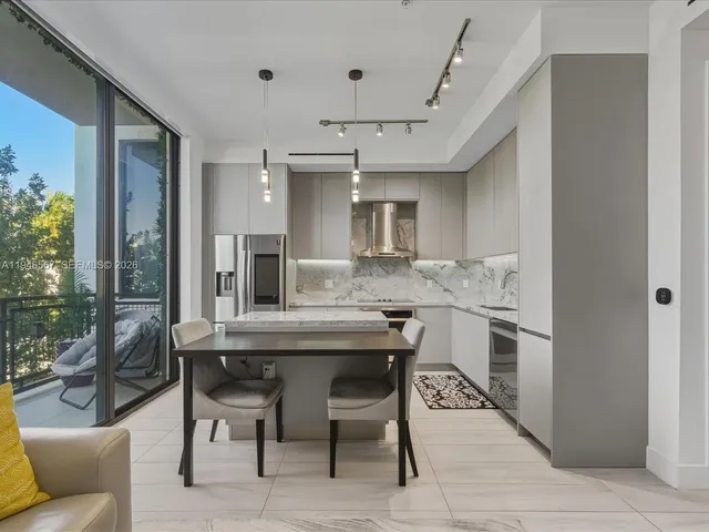 a kitchen with cabinets and chairs in it
