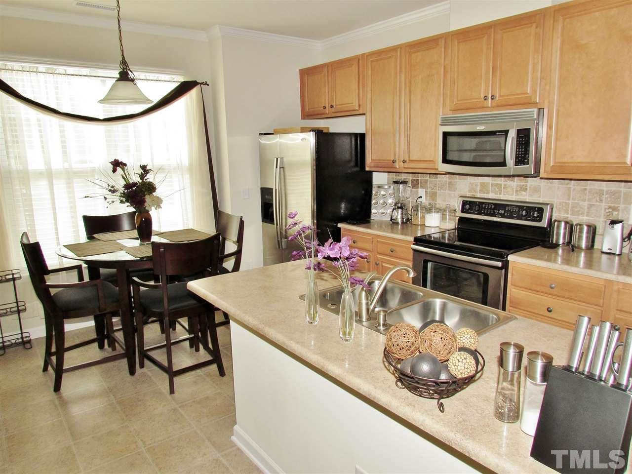 2916 Casona Way Raleigh, NC 27616 - Photo 11 of 25 a kitchen with a table and chairs in it