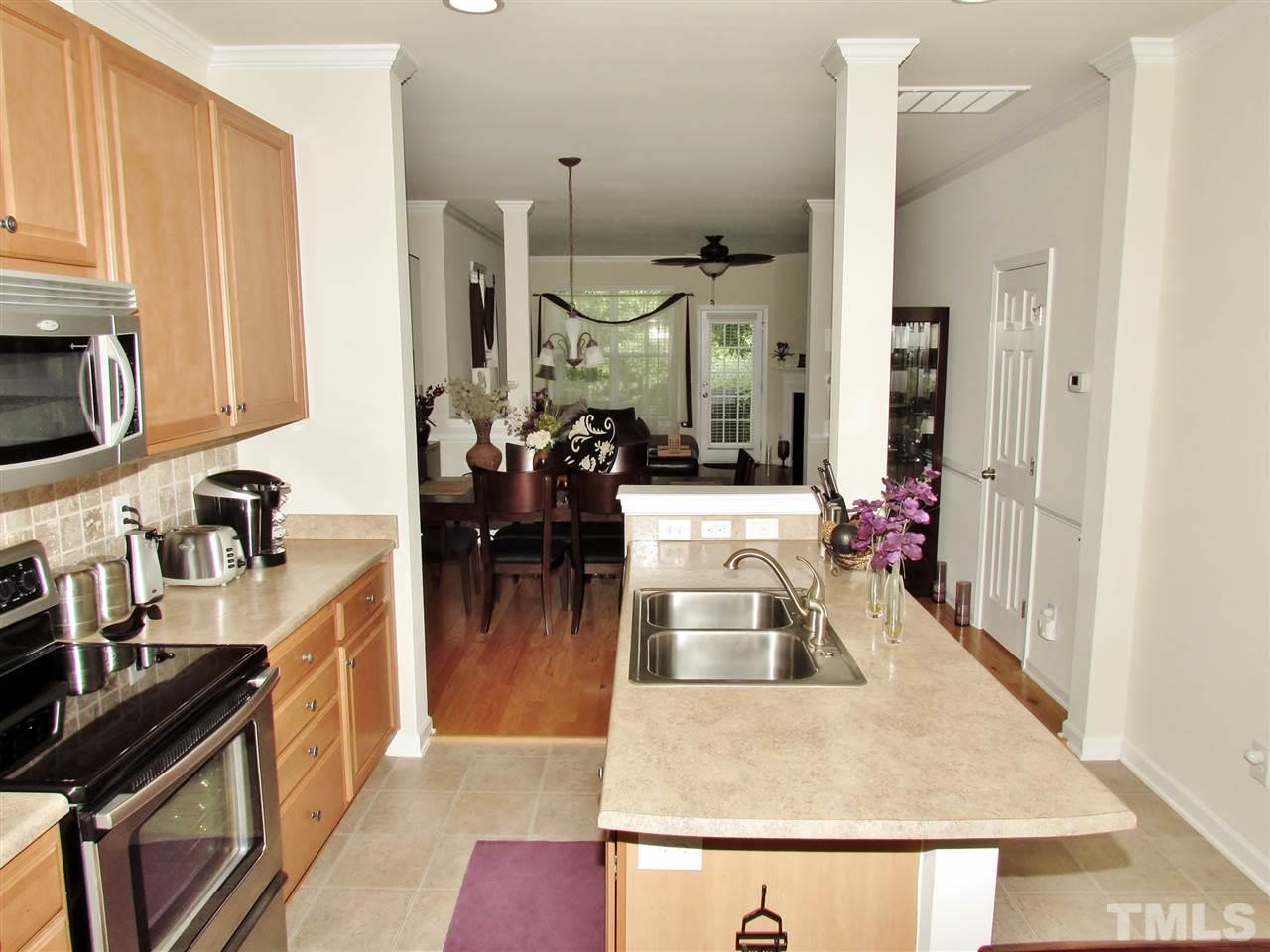 2916 Casona Way Raleigh, NC 27616 - Photo 12 of 25 a kitchen with sink refrigerator and cabinets