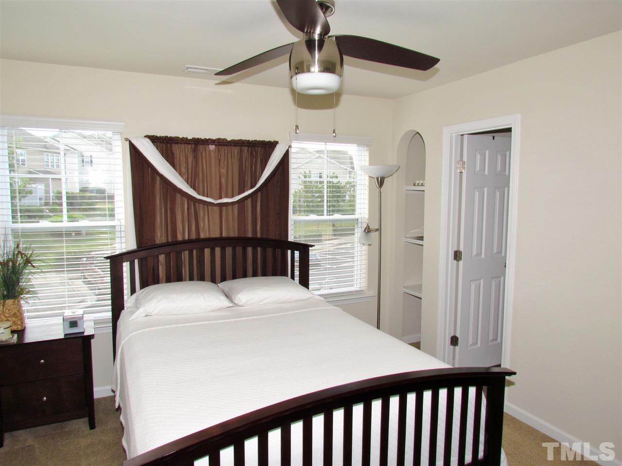 2916 Casona Way Raleigh, NC 27616 - Photo 15 of 25 a bedroom with a bed a window and ceiling fan