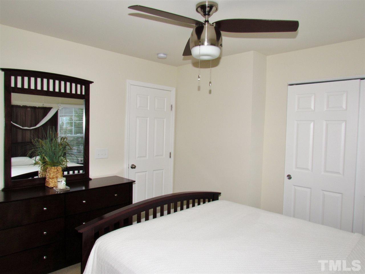 2916 Casona Way Raleigh, NC 27616 - Photo 16 of 25 a bedroom with a bed and a mirror