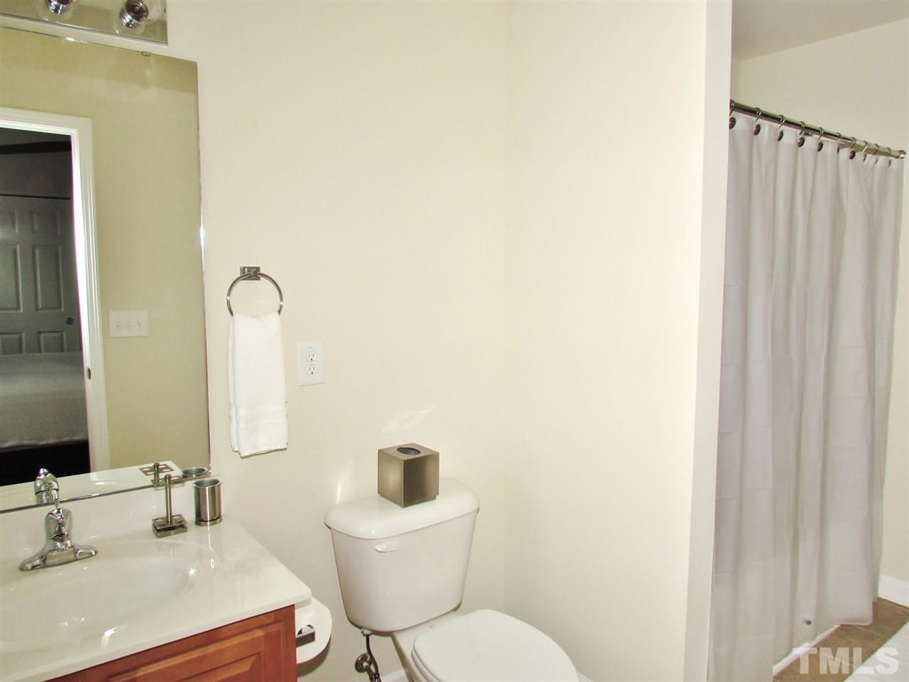 2916 Casona Way Raleigh, NC 27616 - Photo 17 of 25 a bathroom with a sink and a mirror