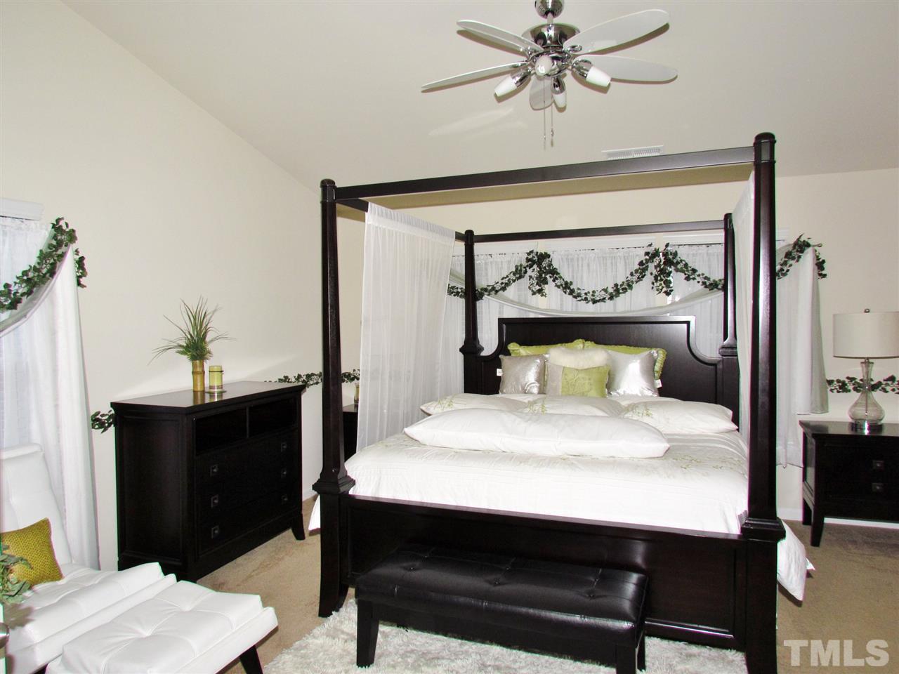2916 Casona Way Raleigh, NC 27616 - Photo 20 of 25 a bedroom with a bed and a table