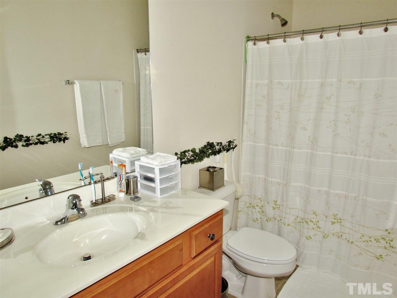 2916 Casona Way Raleigh, NC 27616 - Photo 21 of 25 a bathroom with a sink and a mirror