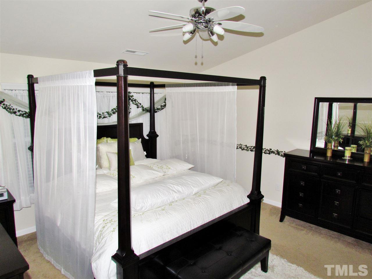 2916 Casona Way Raleigh, NC 27616 - Photo 22 of 25 a bedroom with a bed and a mirror on the dresser