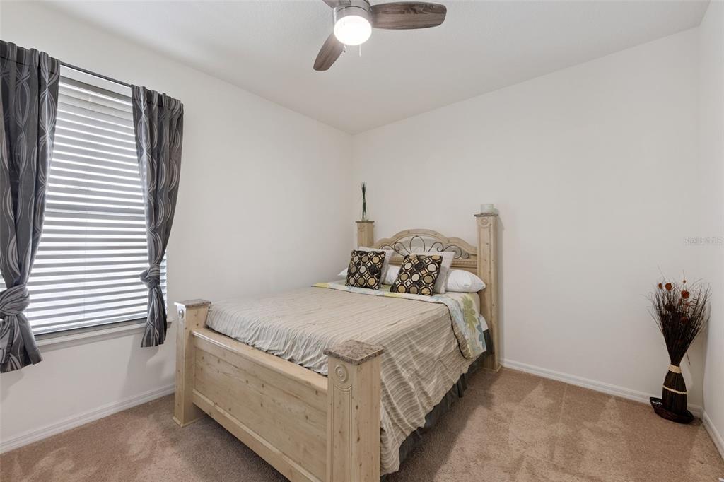 3940 Pine Gate Trail Orlando, FL 32824 - Photo 14 of 36 a bedroom with a bed and a chair