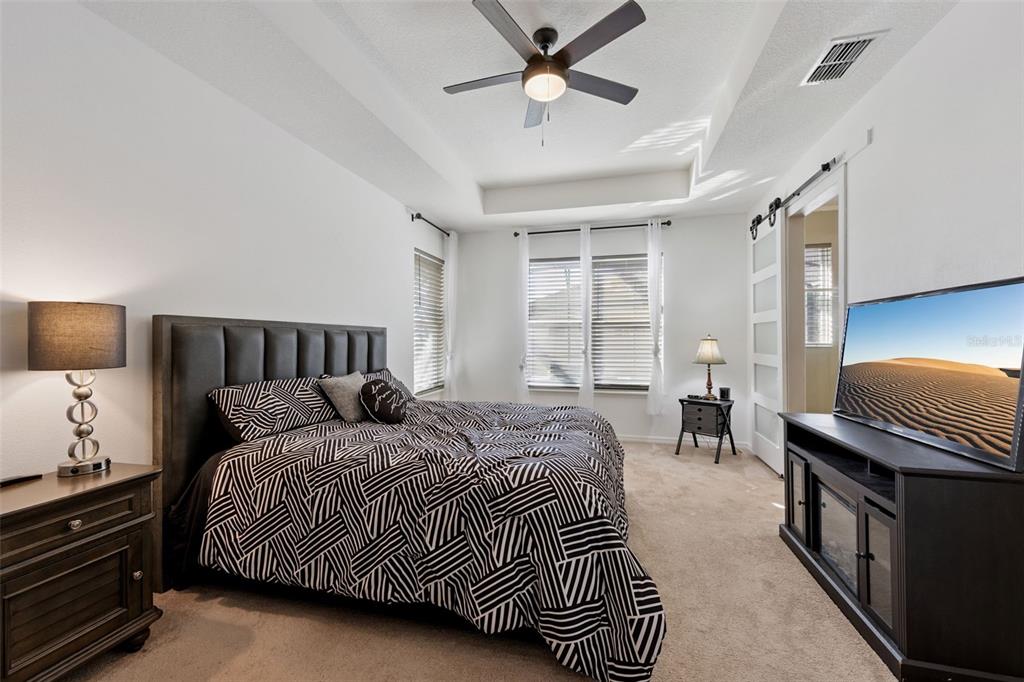 3940 Pine Gate Trail Orlando, FL 32824 - Photo 16 of 36 a bedroom with a bed and a night stand