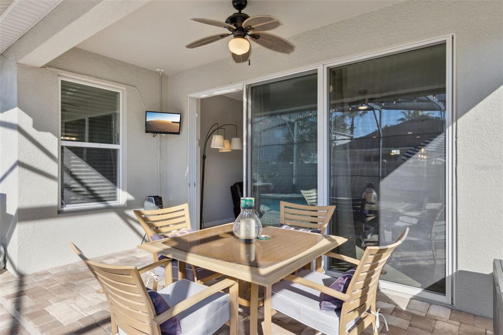 3940 Pine Gate Trail Orlando, FL 32824 - Photo 23 of 36 a view of a dining room with furniture and a chandelier fan