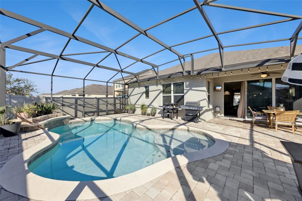 3940 Pine Gate Trail Orlando, FL 32824 - Photo 26 of 36 a view of a swimming pool with a patio