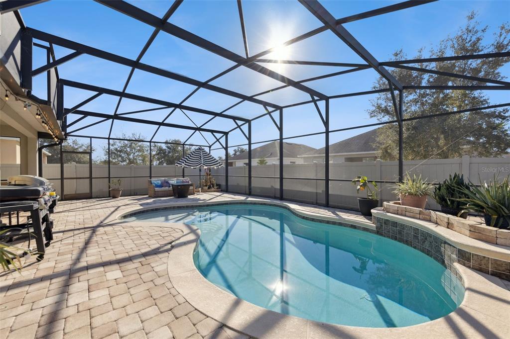 3940 Pine Gate Trail Orlando, FL 32824 - Photo 27 of 36 a view of a swimming pool with a patio
