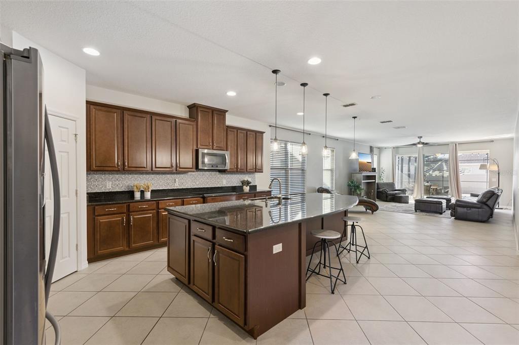 3940 Pine Gate Trail Orlando, FL 32824 - Photo 7 of 36 a kitchen with stainless steel appliances granite countertop a sink stove and refrigerator
