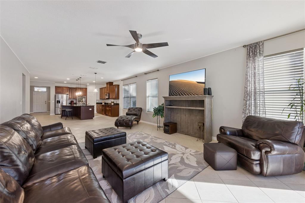 3940 Pine Gate Trail Orlando, FL 32824 - Photo 8 of 36 a living room with furniture a flat screen tv and a window