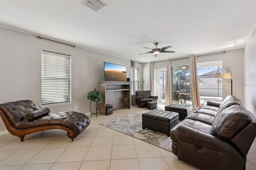 3940 Pine Gate Trail Orlando, FL 32824 - Photo 10 of 36 a living room with furniture ceiling fan and a window