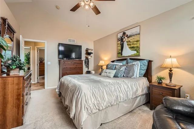 a bedroom with a bed and a television