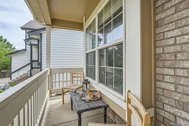 a balcony with furniture and wooden floor