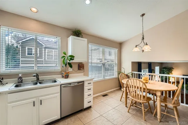 a dining room with furniture a chandelier and window