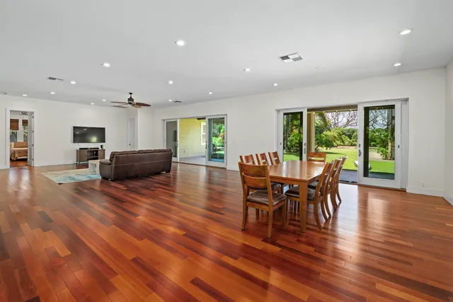 a dining room with furniture and wooden floor