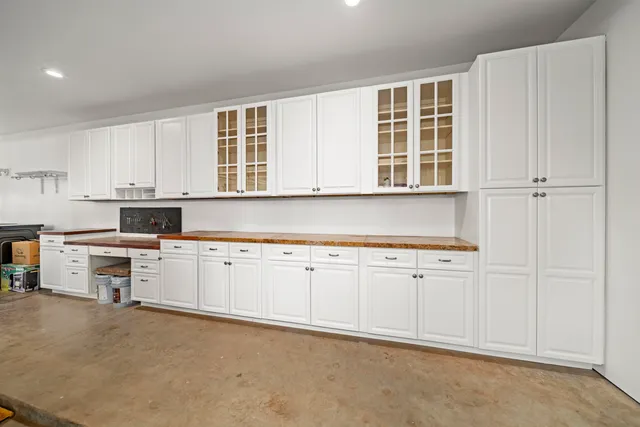 a spacious bedroom with a bed and a ceiling fan