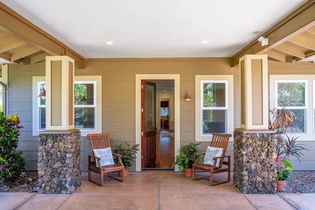 a view of front door of house with outdoor seating