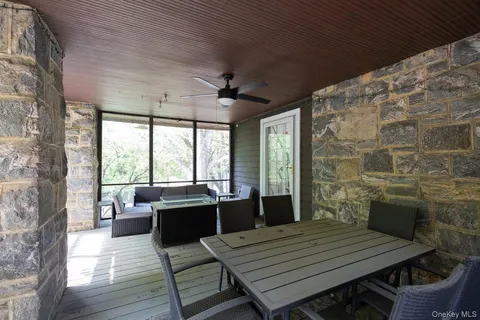 a dining room with wooden floor and furniture