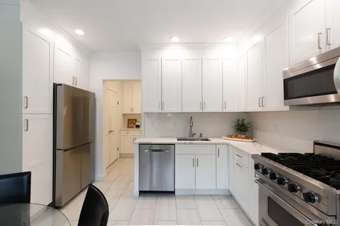a kitchen with stainless steel appliances a refrigerator stove and sink