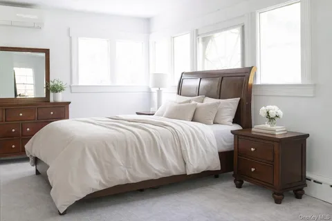 a bedroom with a bed and window