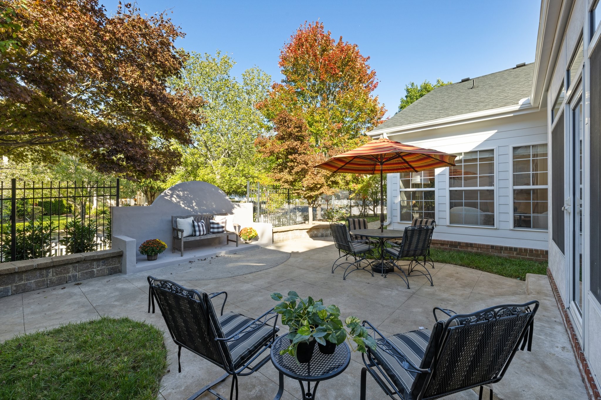 541 Marigold Drive Franklin, TN 37064 - Photo 61 of 69 a view of a patio with table and chairs under an umbrella with a fire pit