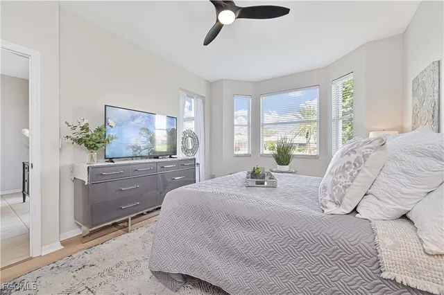 a bedroom with a bed and ceiling fan