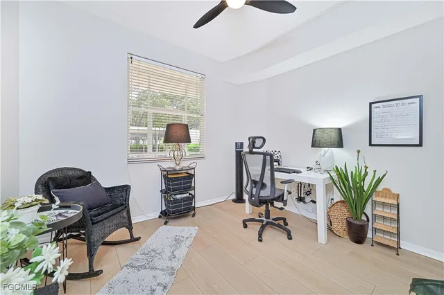 a dining room with furniture and a potted plant