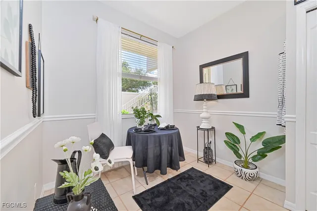 a dining room with furniture and a potted plant